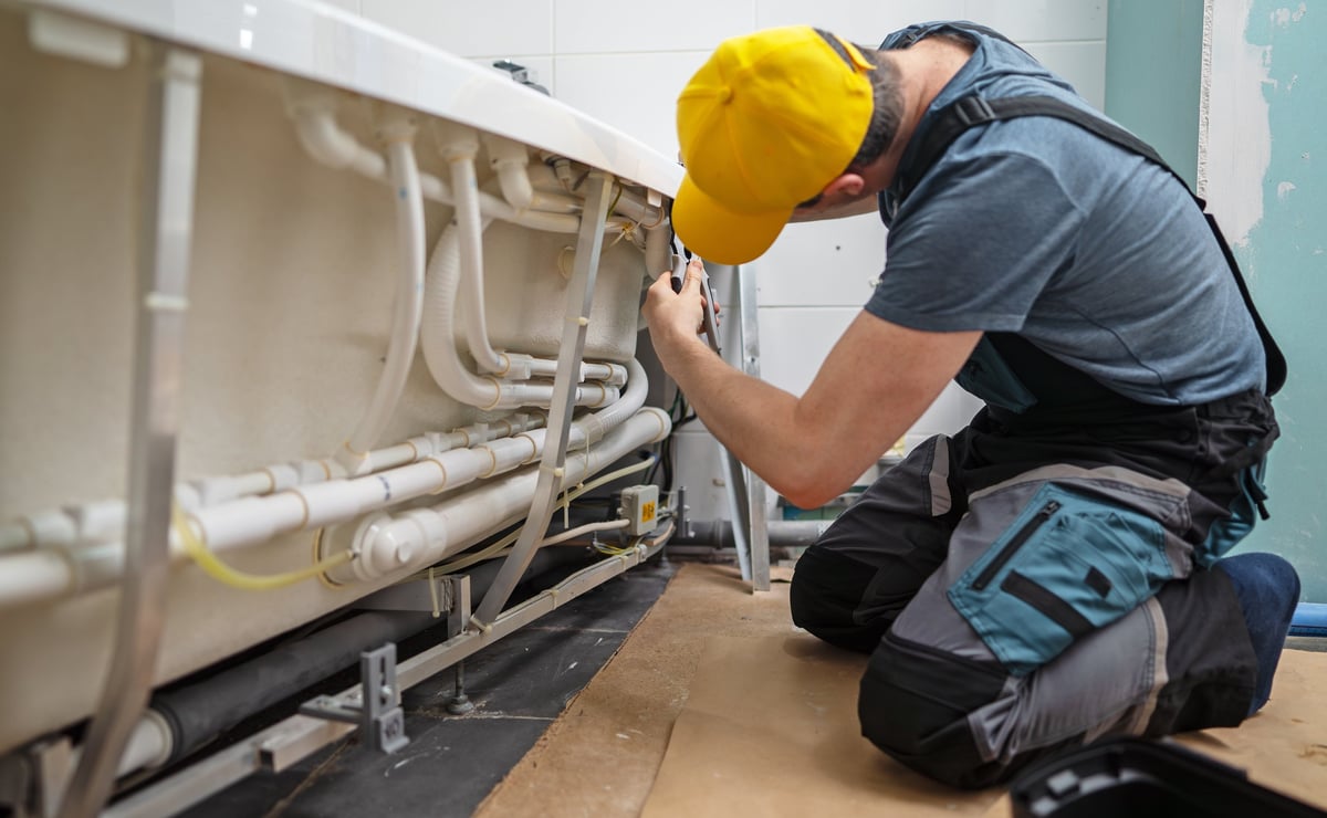 Service technician maintaining a commercial hydromassage pipe system